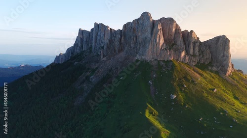 Drone view of scenic dolomite mountain with rock and morning sunshine in Caucasus
