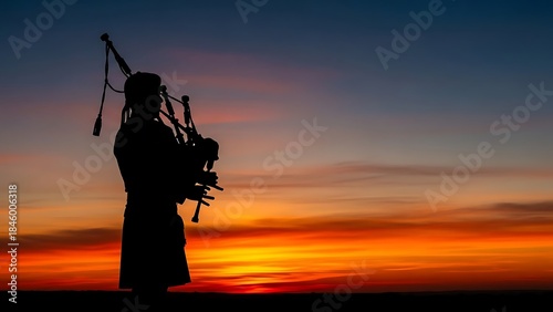 Silhouette of a bagpiper playing against a dramatic and colorful sunset sky, evoking a sense of tradition and music.