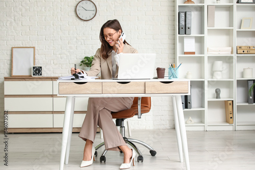 Smiling businesswoman talki...