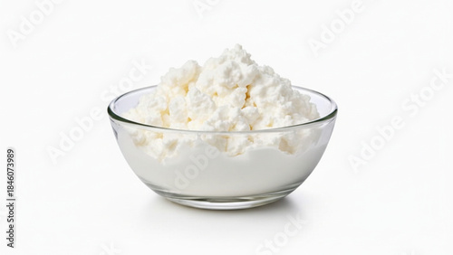 Fresh cottage cheese in a clear glass bowl on white background