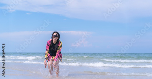 Happy Asain Woman Enjoying Beach Lifestyle in Swimsuit