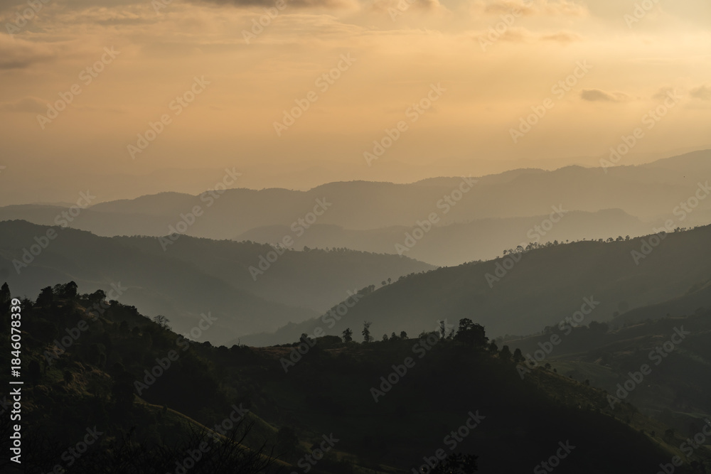 Fototapeta premium Serene Mountain Landscape at Dusk with Layered Hills and Soft Hues in the Sky Offering a Tranquil Nature Escape for Adventurous Souls