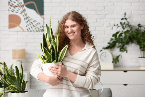 Smiling young woman holding...