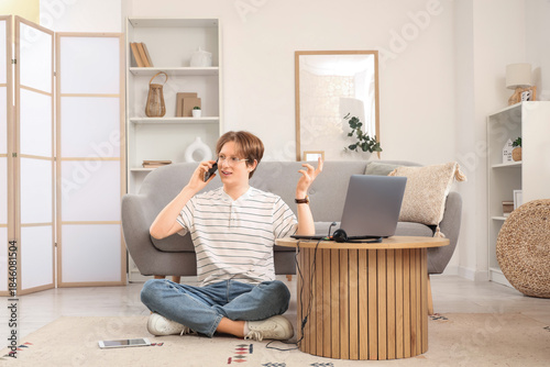 Teenage boy with laptop, ta...