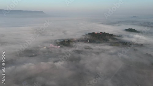 Aerial view of fog covered small hills in Pa Daet district one of the southern part of Chiang Rai province of Thailand during winter season.