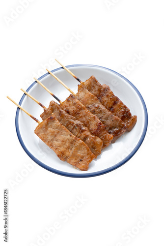 Thai BBQ Pork Skewers in plate isolated on white