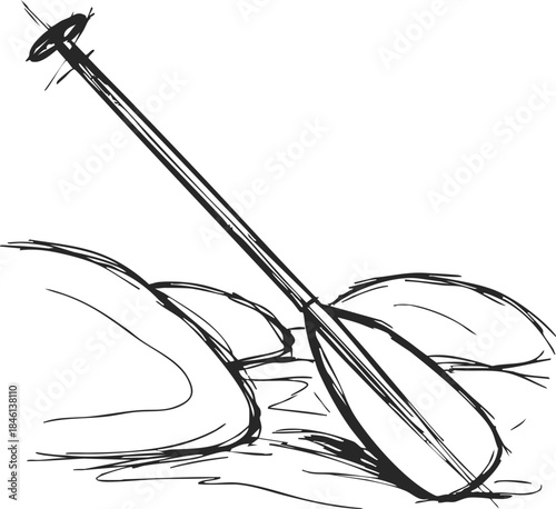 Canoe paddle resting on riverside rocks