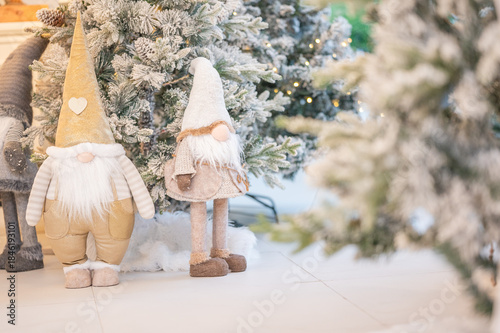 Blue Christmas tree with snowflakes falling on its branches