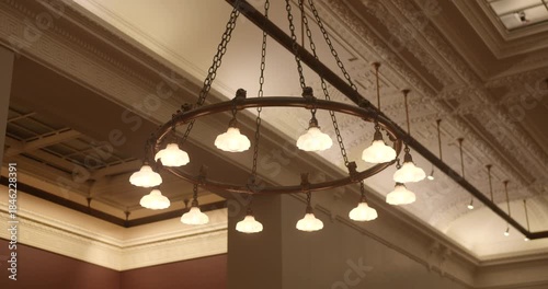 Round Vintage-Style Iron Chandelier With Multiple Frosted Glass Dome Lights Inside The Public Library Of New York City, USA. Low Angle Shot