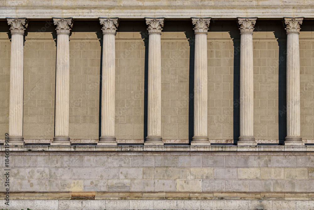Naklejka premium Columns and wall of an old building as an abstract background, architectural details