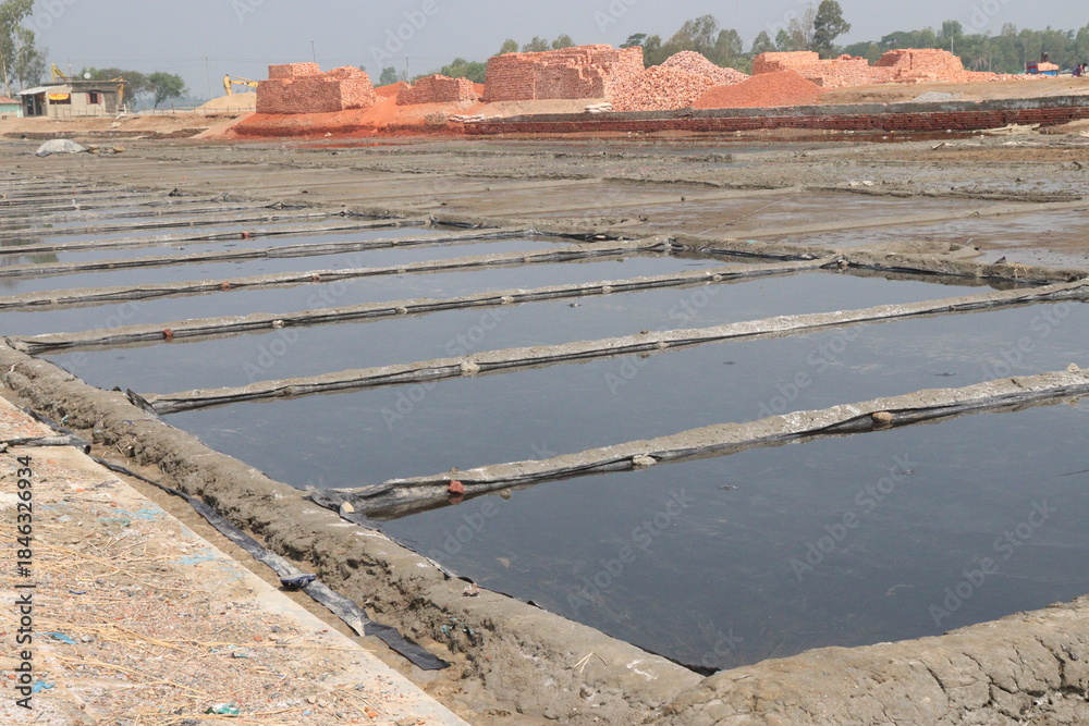 Obraz premium raw salt farm plot with water and polythene bed