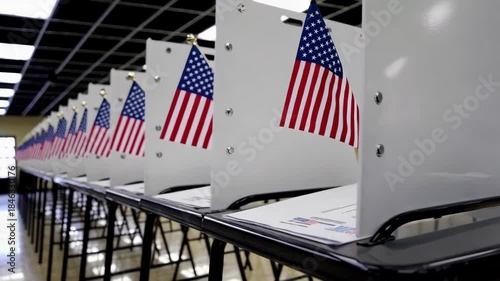 A row of voting booths with American flags set up in a polling place.