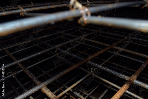 piles of iron being assembled to form the foundation of a building
