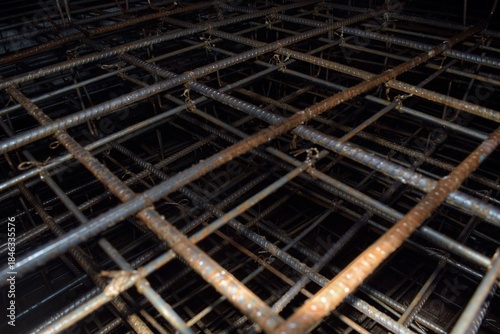 piles of iron being assembled to form the foundation of a building