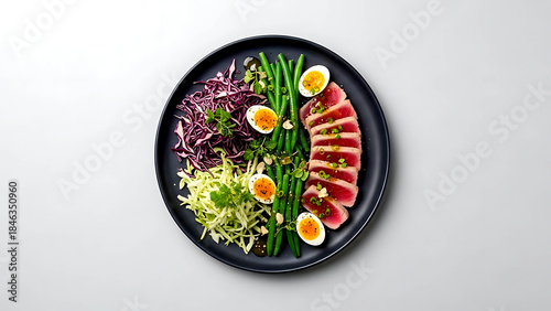 Minimalist flat lay, a modern Nicoise-inspired salad with finely shredded cabbage, seared tuna, green beans, quail eggs, arranged precisely on a slate gray plate 
