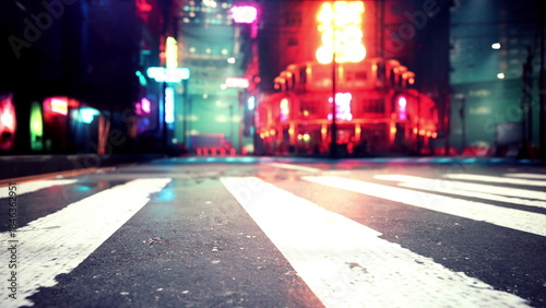 Slika na platnu Vibrant city streets come alive at night, showcasing colorful neon lights from nearby buildings