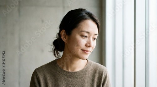 A contemplative woman gazes...