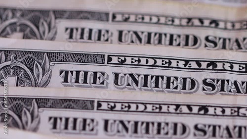 Macro view of one-dollar banknotes arranged in a row, representing the concept of the foreign exchange market and the strength or devaluation of the US dollar.