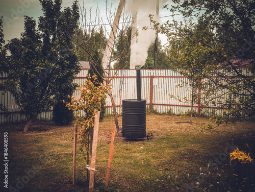 Garbage incinerator in the yard of a rural house