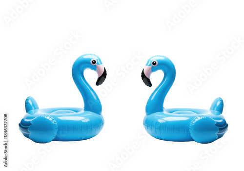 Two vibrant blue glossy plastic flamingo pool floats, one facing left and one right, against a transparent studio background with copy space, concept for summer advertising