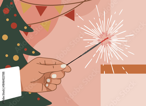 Hand holding a lit sparkler at a Christmas or New year party. Holiday celebration and festive mood concept for greeting card.