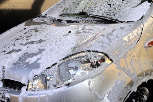 Gray car at self-service car wash. Washing car