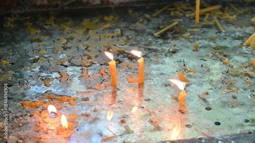 Burning prayer candles in a designated candle-burning area inside a Christian church, symbolizing faith, prayer, and spirituality.