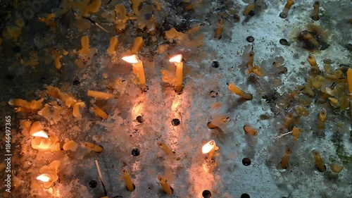 Burning prayer candles in a designated candle-burning area inside a Christian church, symbolizing faith, prayer, and spirituality.