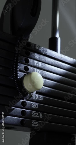Close-up of a gym machine in action in a ray of light.