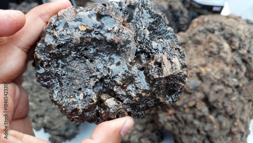 Foto Raw Shilajit Ore Held Showing Resinous Mineral Texture