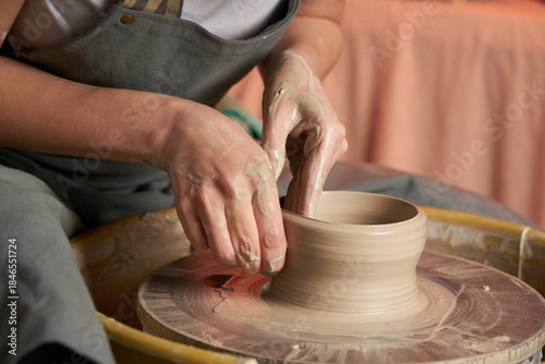 Pottery class. Hands hols clay on a  potter's wheel
