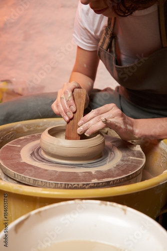 Pottery class. Hands hols clay on a  potter's wheel