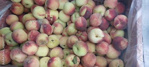 Ripe peaches in a plastic bag on the counter of the store