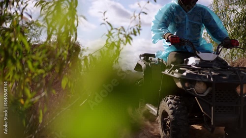 ATV riders on sandy trail kick up dust while powering through sunlit scrubland, low angle shots emphasize speed and rugged terrain, loose sand, tire tracks.