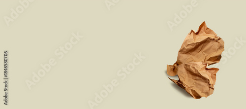 Brown paper, paper scrap, isolated. Modern abstract artistic image. Sustainable packaging, sustainable use of materials, crumpled used paper. Minimalist paper wallpaper