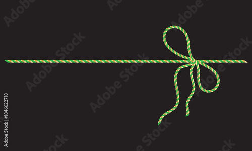 Green and gold String Rope with Crossed Bow Isolated on black background. symbolizing gift wrapping, holidays, celebration, and handmade packaging on black  background.