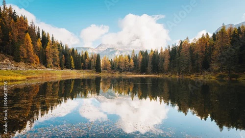 Lago d Antorno with Tre Cime Peak and autumn larch forest reflection on sunny day in Dolomites, Italy
