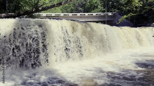 Raging water runoff after a massive storm shows Potter’s Falls in Tennessee moving a large volume of dirty water down the Obed River.