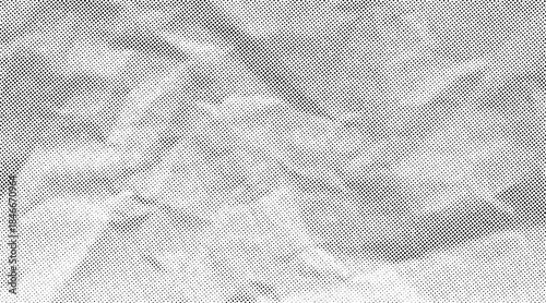 Halftone crumpled paper texture with black a dotted, rough, and wrinkled surface. Wite creased sheet background in comic pop-art style, featuring grainy folds and gritty distressed details.