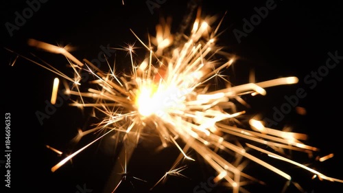 Glowing sparklers isolated on black background. Handheld sparklers with light trails on black. Festive sparklers in the dark.