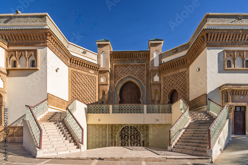 Moroccan Mosque Exterior With Tall Minaret And Ornate Entrance Under Blue Sky, Agadir