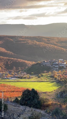 Aerial View of Autumn Valley with Sunlit Green Meadow