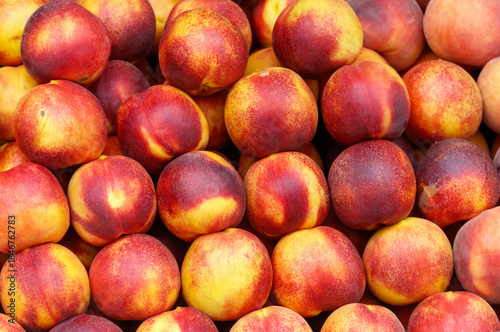 A bunch of red and yellow peaches