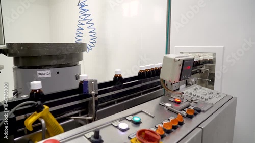Automated ampoule filling and sealing conveyor line in pharmaceutical production facility