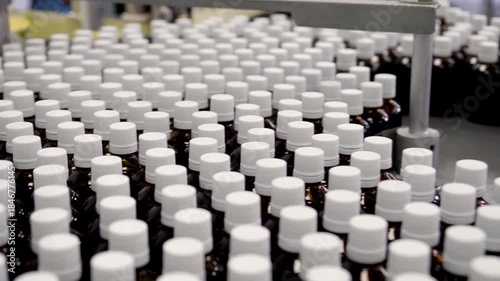 Automated ampoule filling and sealing conveyor line in pharmaceutical production facility