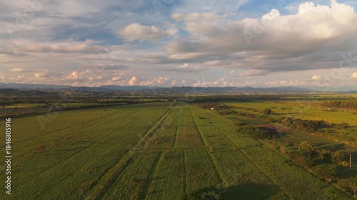 aerial view of a vast farm in the countryside of Brazil with moutains in the distance during sunset