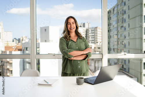 Photography Latin businesswoman in her 30s with bright smile wearing green shirt standing co
