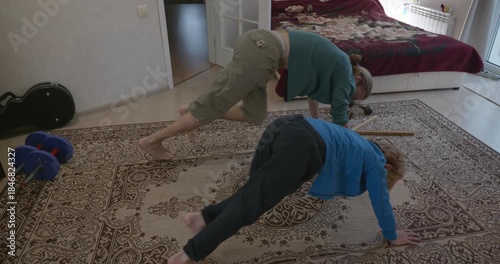 Man Does Exercise Workout with Kid at Home. 4K 10-bit