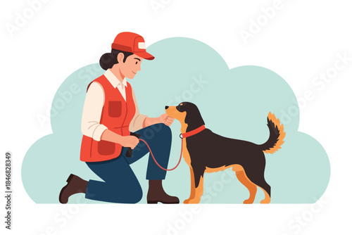 A woman in a red hat and vest kneels to interact with a dog on a leash