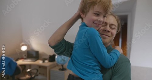 Man Hugs Child in Room at Home. 4K 10-bit